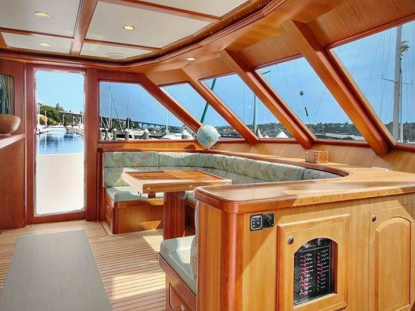 a room with a large window and wood cabinets aboard FOLIE DEUX Yacht for Sale