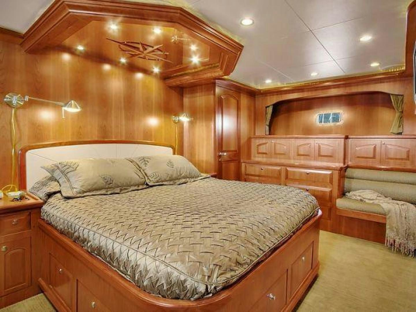 a bedroom with a bed and a wooden wall aboard FOLIE DEUX Yacht for Sale