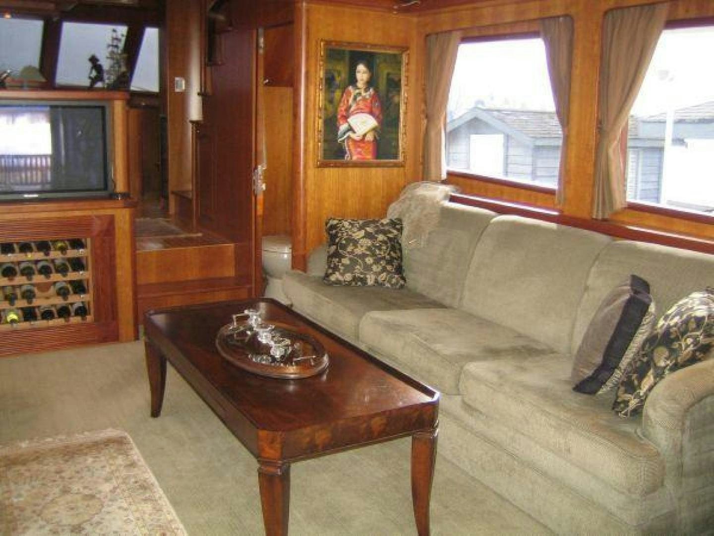 a living room with a couch and a coffee table aboard FOLIE DEUX Yacht for Sale