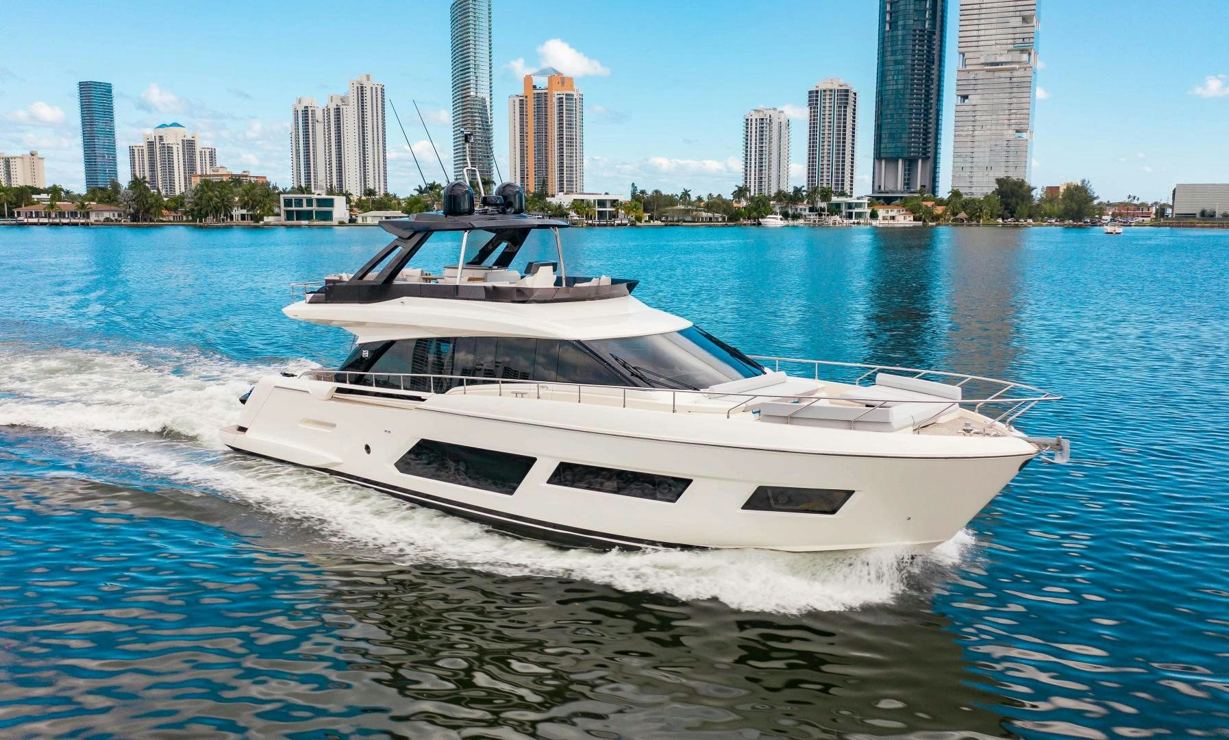 a white boat on the water aboard OUR TRADE Yacht for Sale