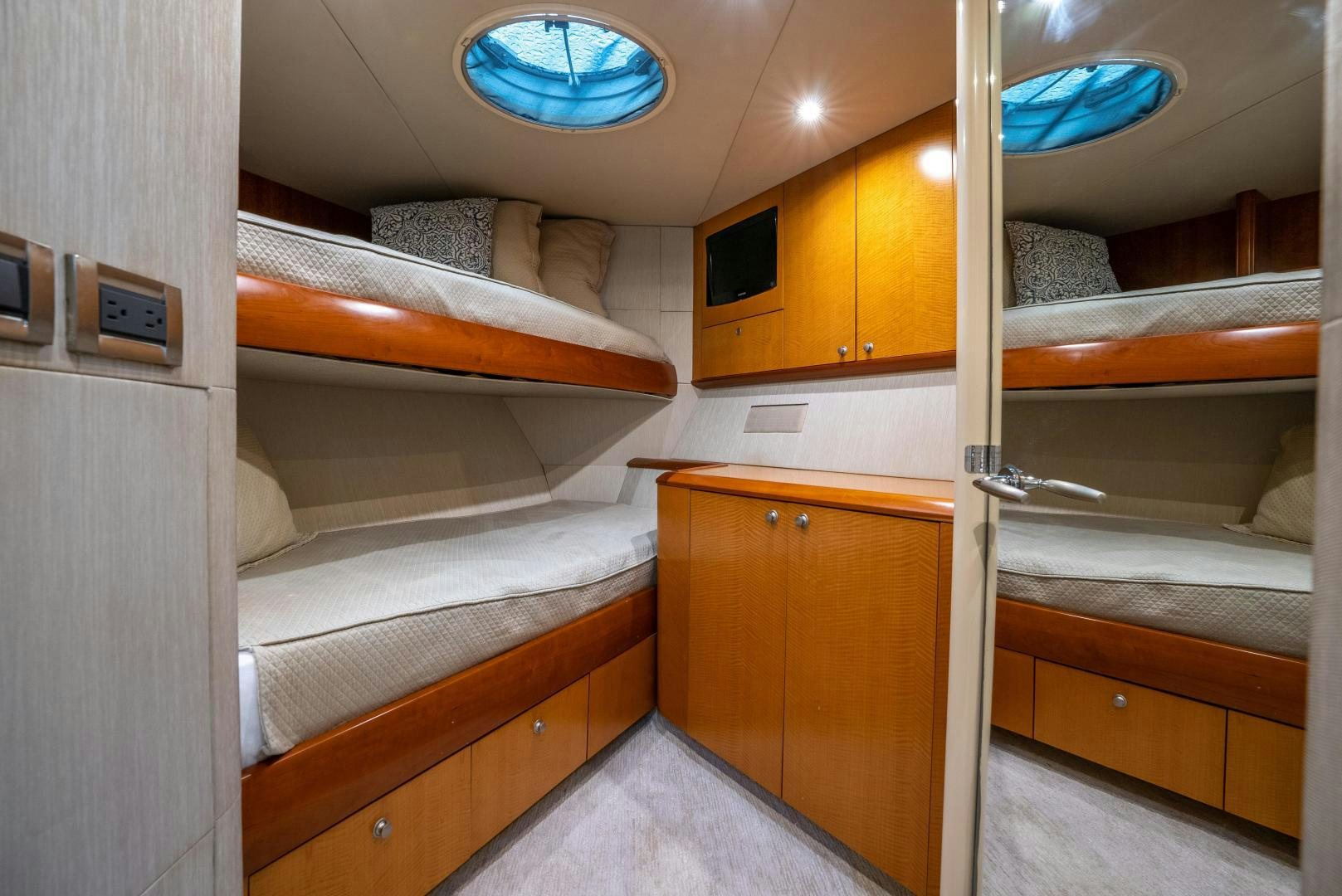 a room with a bed and cabinets aboard STARFIRE Yacht for Sale