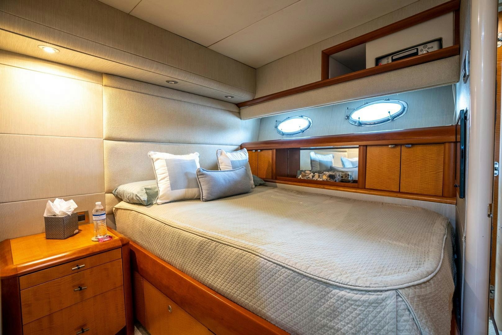 a bed with a white comforter aboard STARFIRE Yacht for Sale