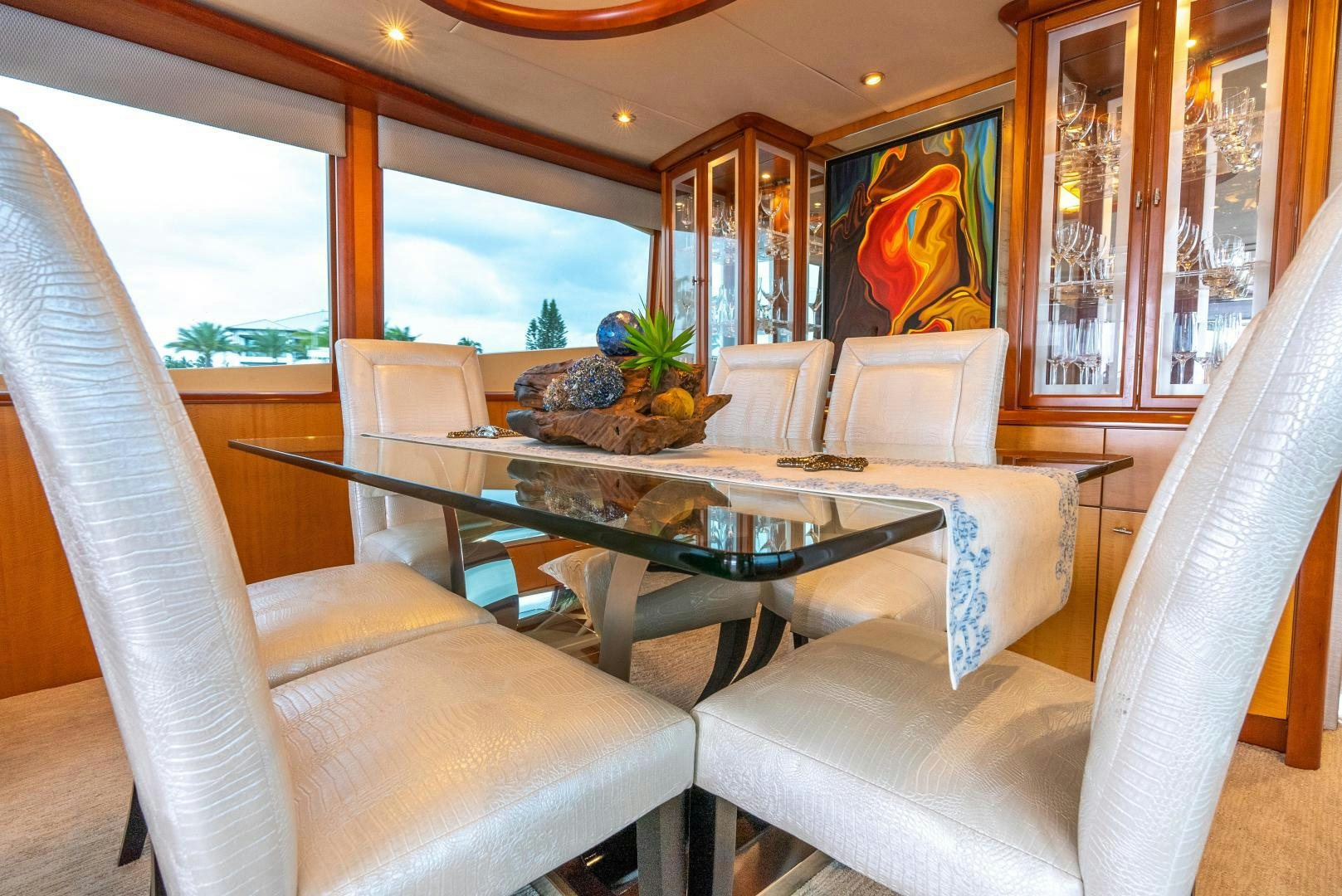 a room with a table chairs and a couch aboard STARFIRE Yacht for Sale