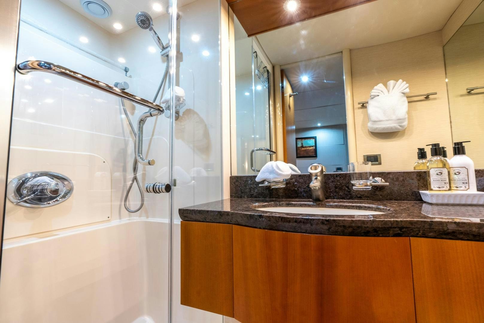 a bathroom with a glass shower aboard STARFIRE Yacht for Sale