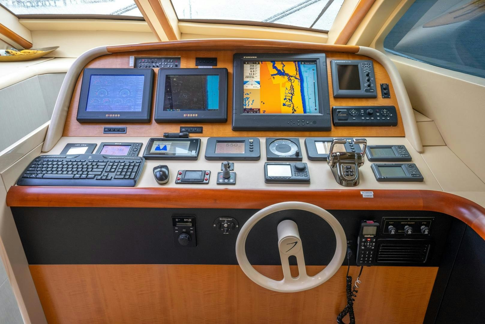 a wooden desk with electronic devices aboard STARFIRE Yacht for Sale