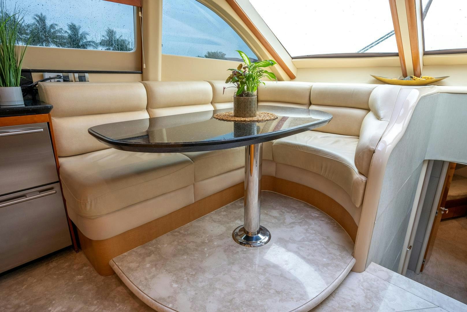 a table and a couch in a room aboard STARFIRE Yacht for Sale
