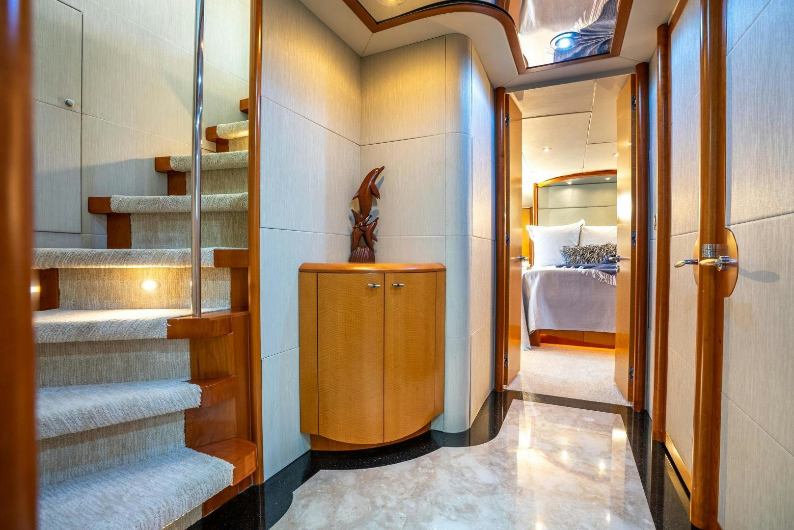 a room with a bed and a dresser aboard STARFIRE Yacht for Sale