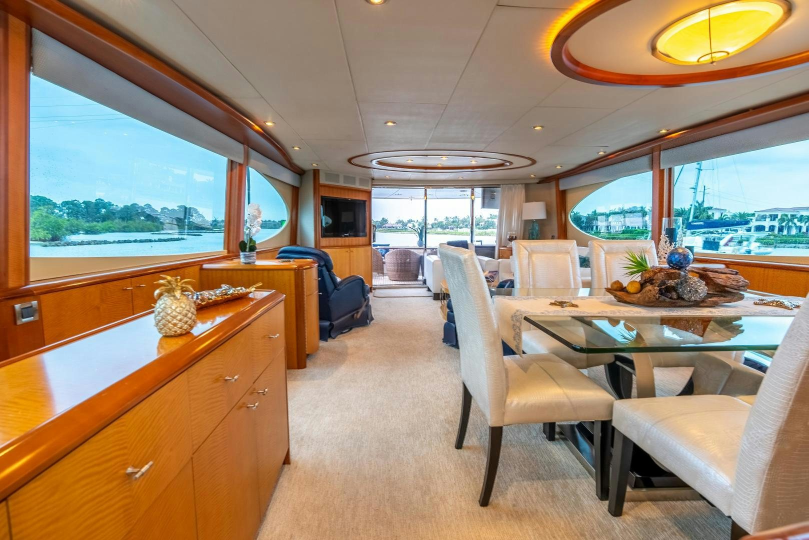 a large room with a table and chairs aboard STARFIRE Yacht for Sale
