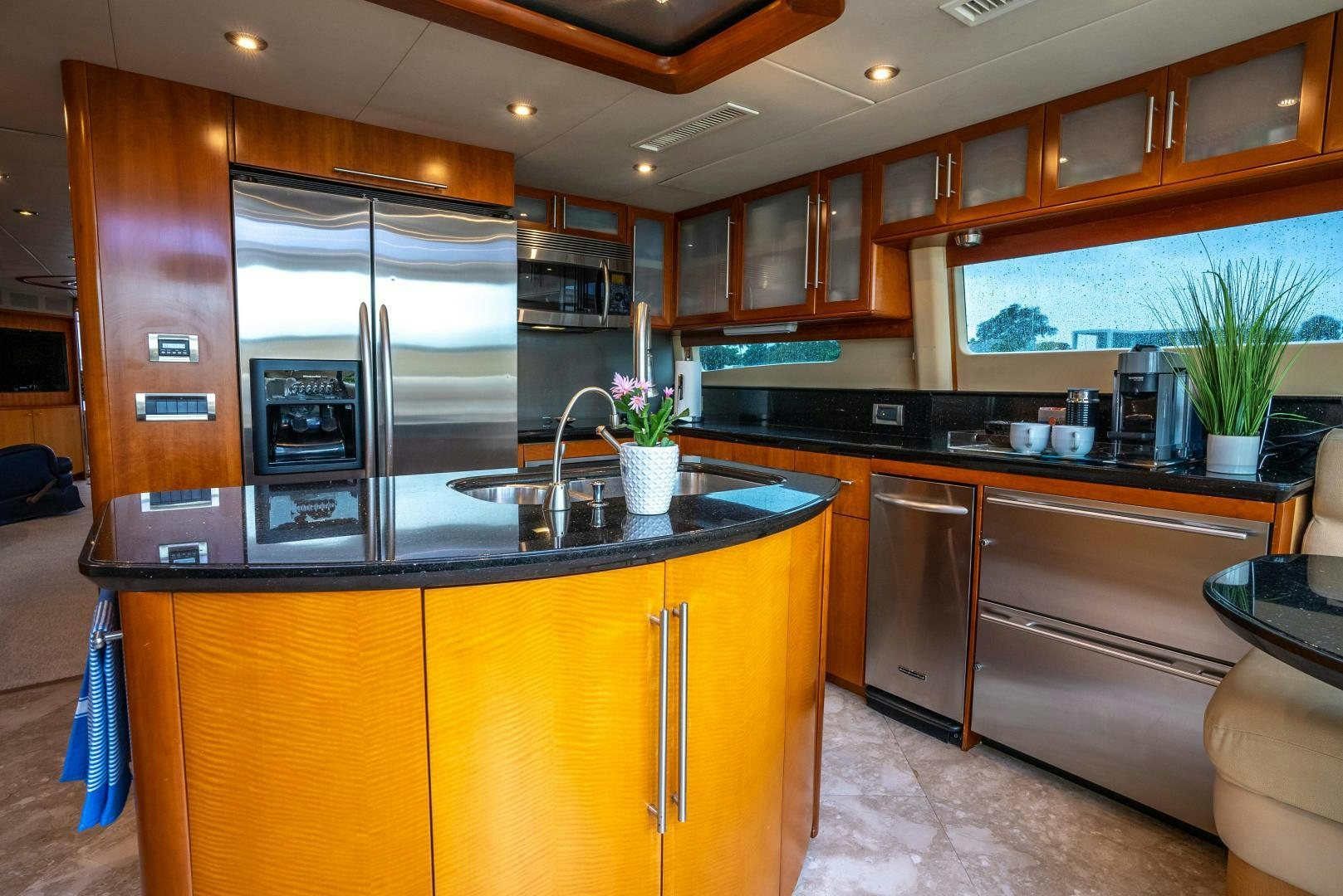 a kitchen with wooden cabinets aboard STARFIRE Yacht for Sale