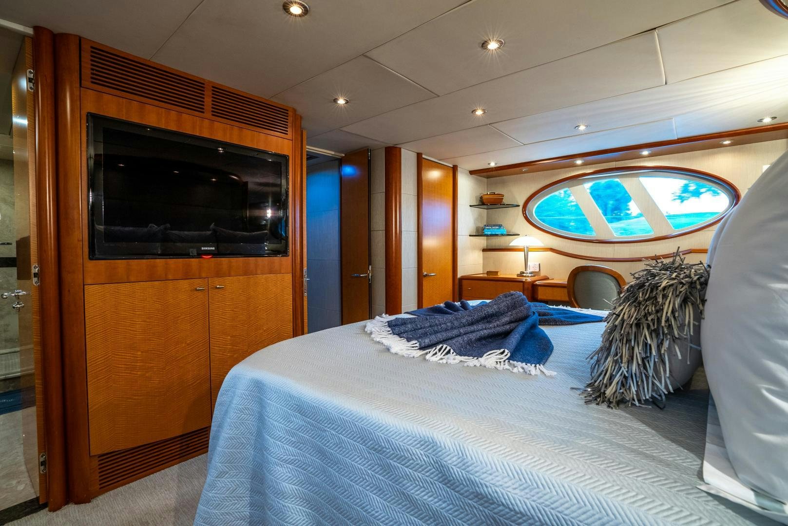 a bedroom with a bed and a television aboard STARFIRE Yacht for Sale