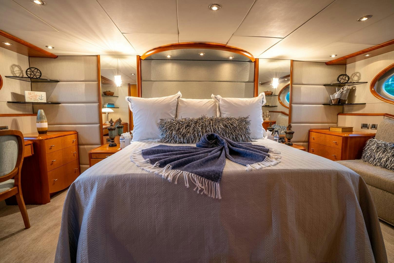 a bed with a blue comforter aboard STARFIRE Yacht for Sale