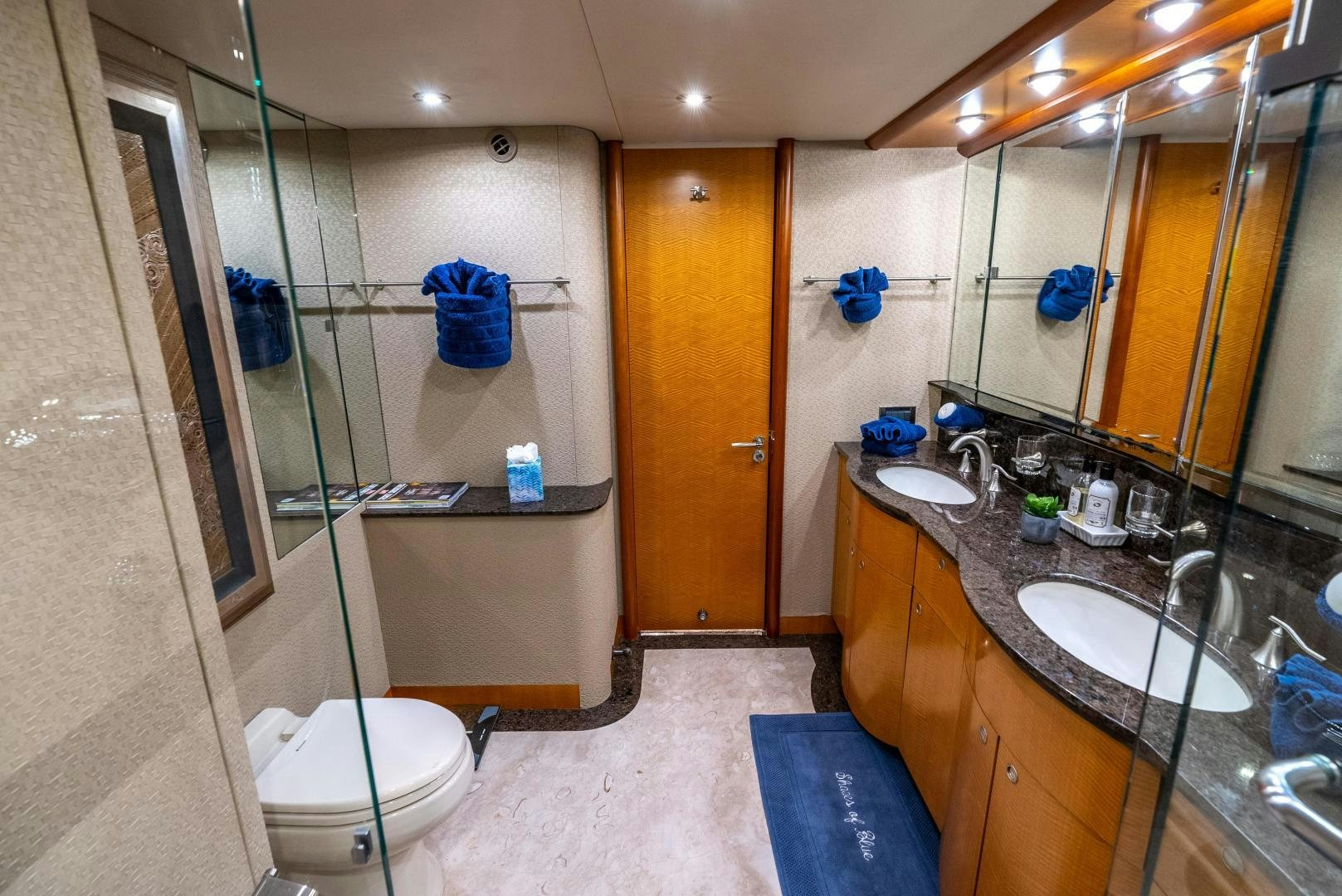 a bathroom with a toilet sink and a mirror aboard STARFIRE Yacht for Sale