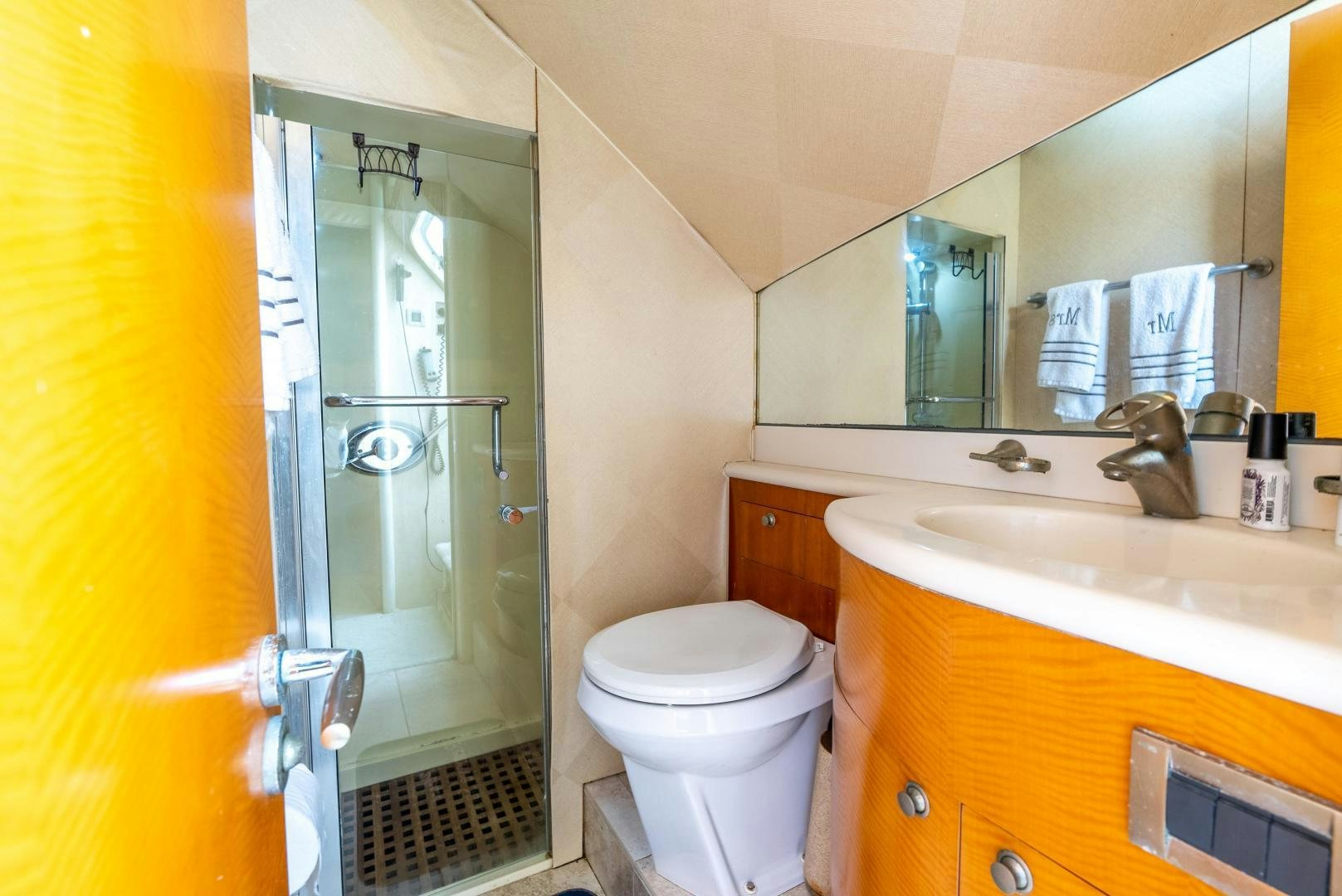 a bathroom with a glass shower door aboard STARFIRE Yacht for Sale