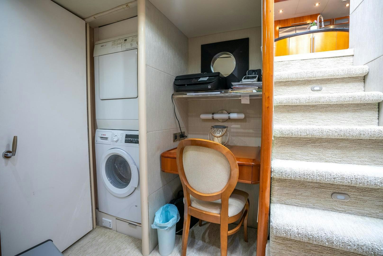 a small room with a washing machine and a chair aboard STARFIRE Yacht for Sale