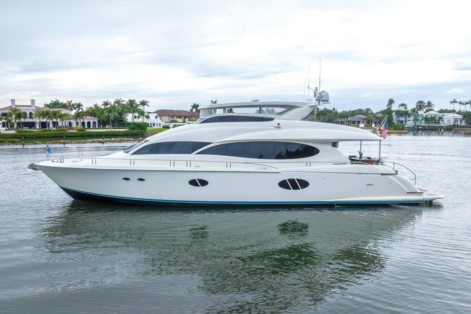 a white yacht in a harbor aboard STARFIRE Yacht for Sale