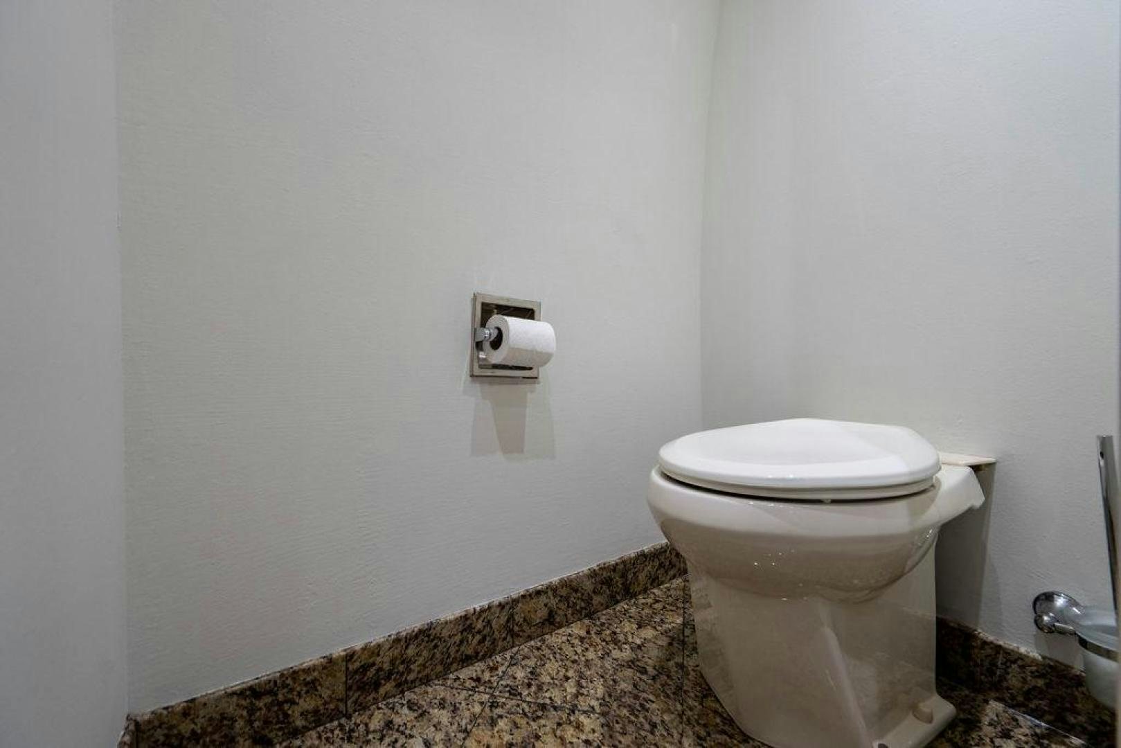 a toilet with rolls of toilet paper on the wall aboard THREE BLESSINGS Yacht for Sale