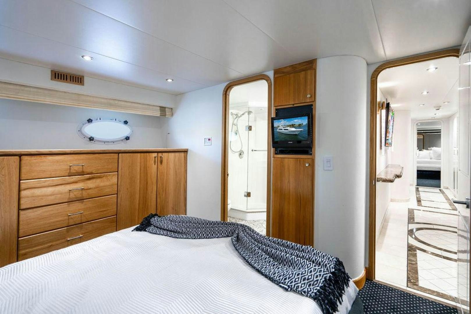 a bedroom with a bed and a television aboard THREE BLESSINGS Yacht for Sale
