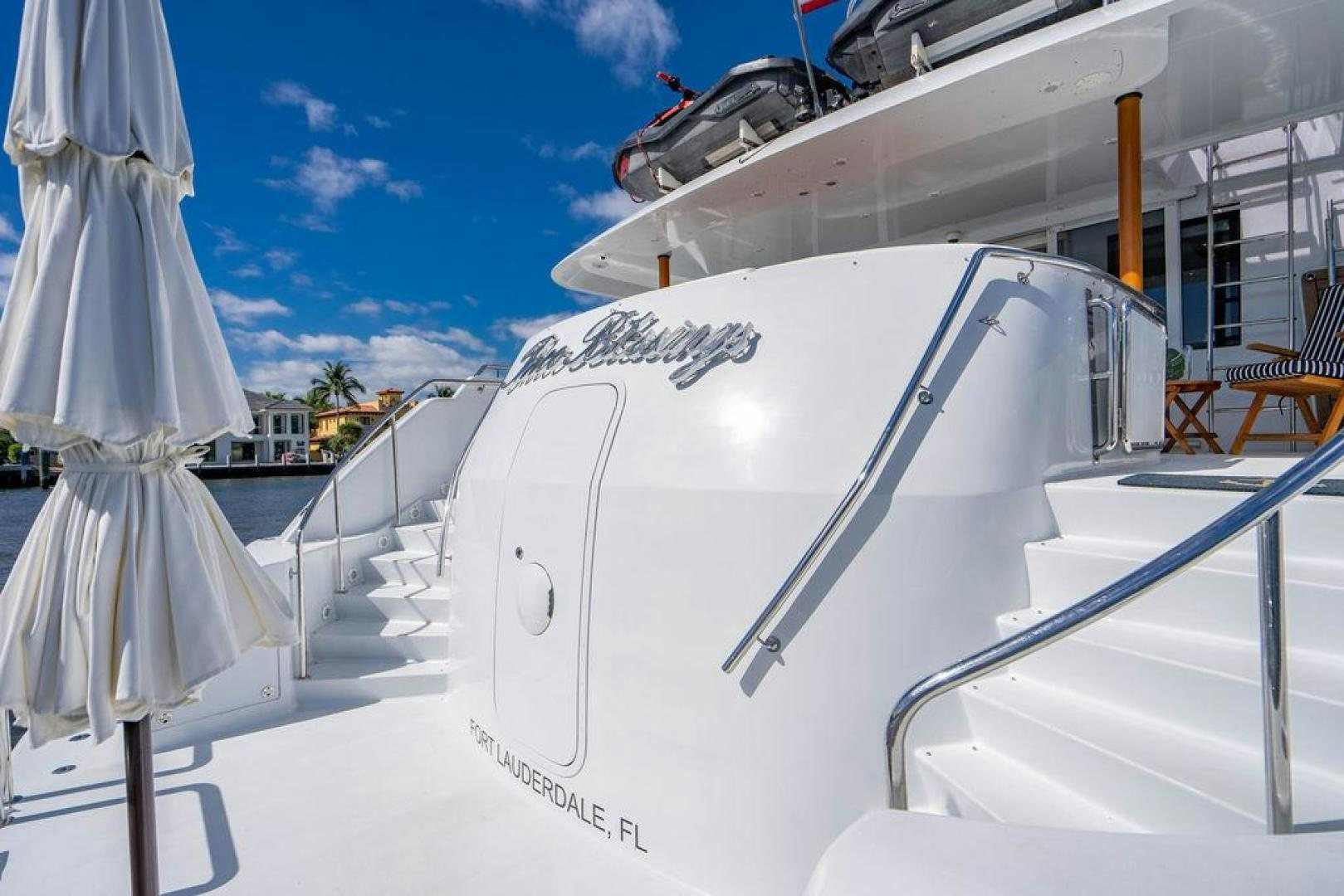 a white boat on a beach aboard THREE BLESSINGS Yacht for Sale