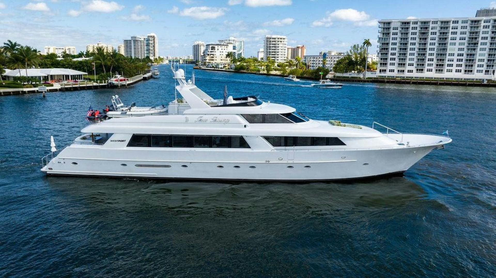 a white yacht in the water aboard THREE BLESSINGS Yacht for Sale