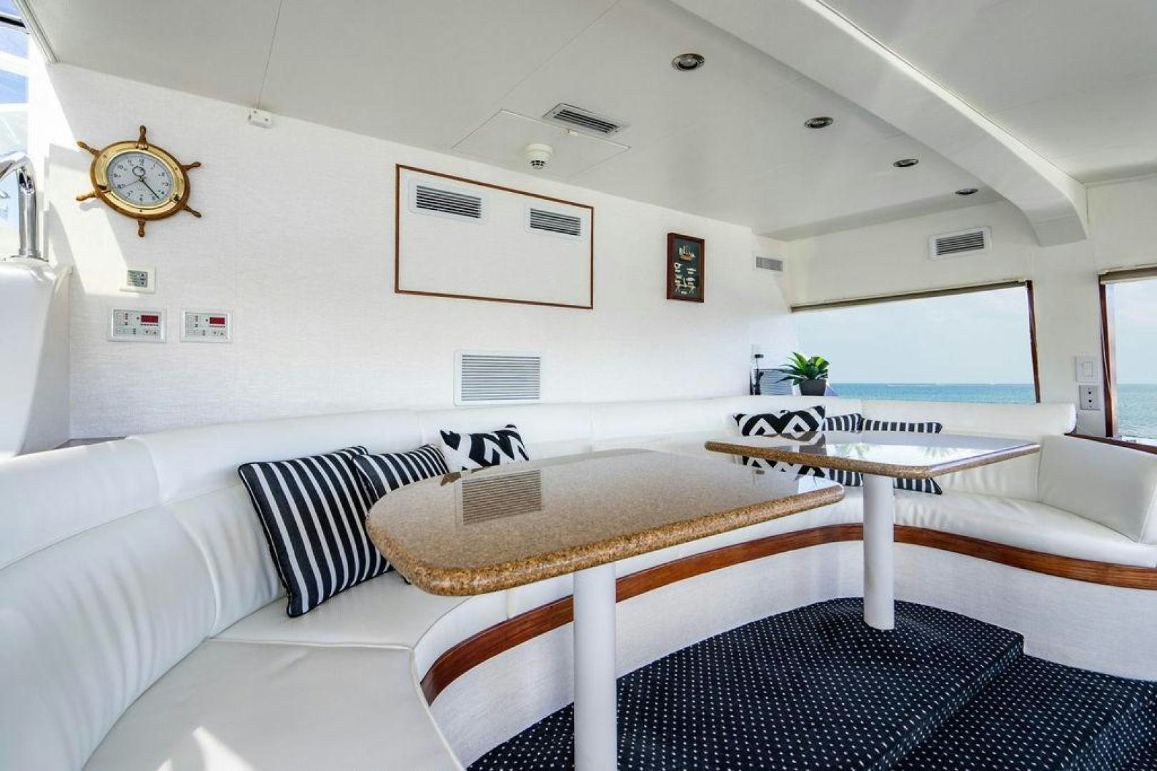 a living room with a couch and a table aboard THREE BLESSINGS Yacht for Sale