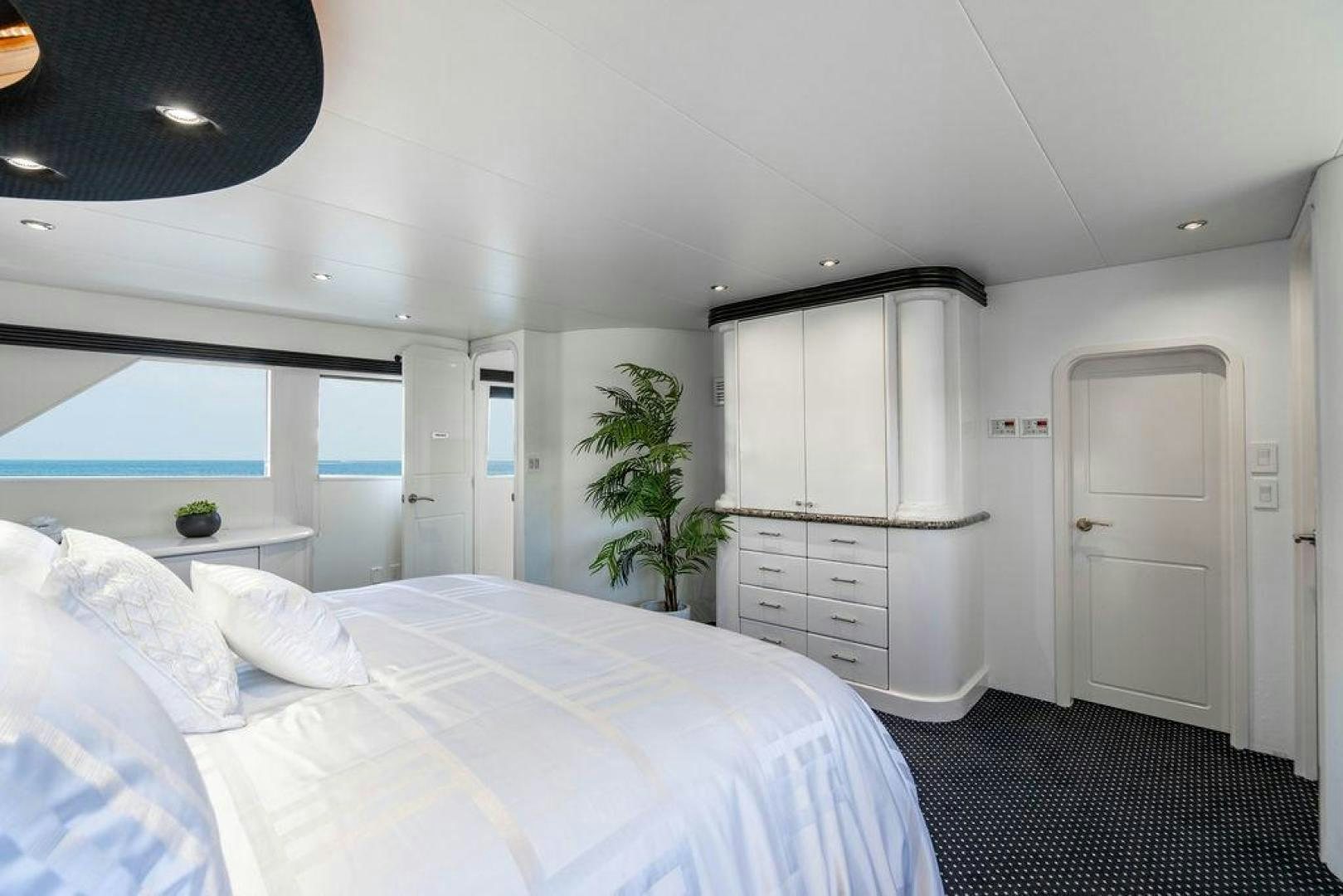a bedroom with a bed and a plant aboard THREE BLESSINGS Yacht for Sale
