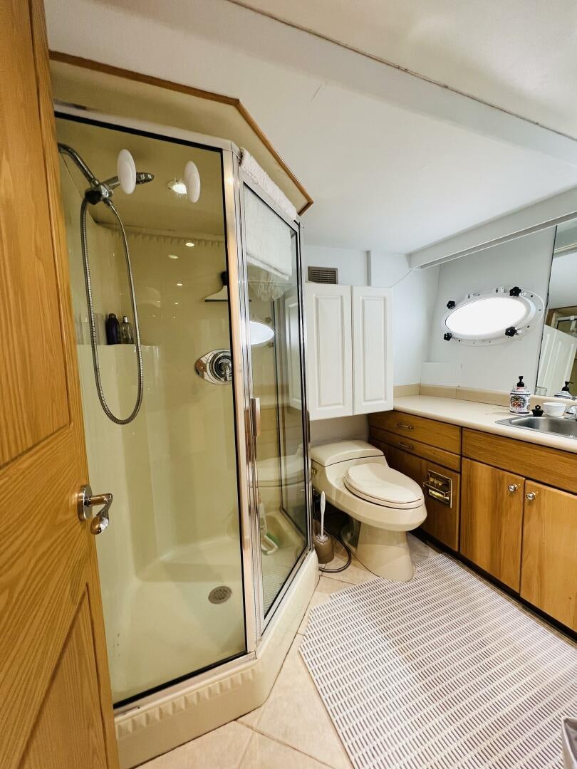 a bathroom with a glass shower door aboard THREE BLESSINGS Yacht for Sale