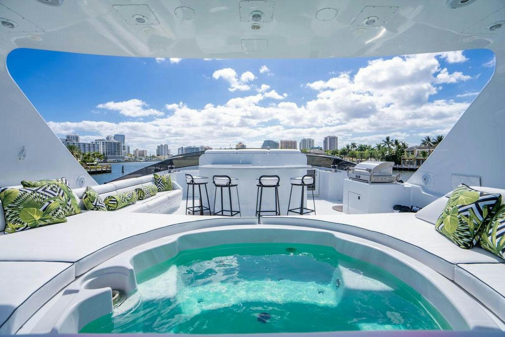 a swimming pool with a city in the background aboard THREE BLESSINGS Yacht for Sale