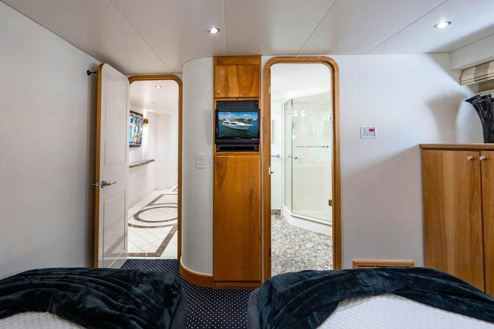 a bedroom with a tv on the wall aboard THREE BLESSINGS Yacht for Sale