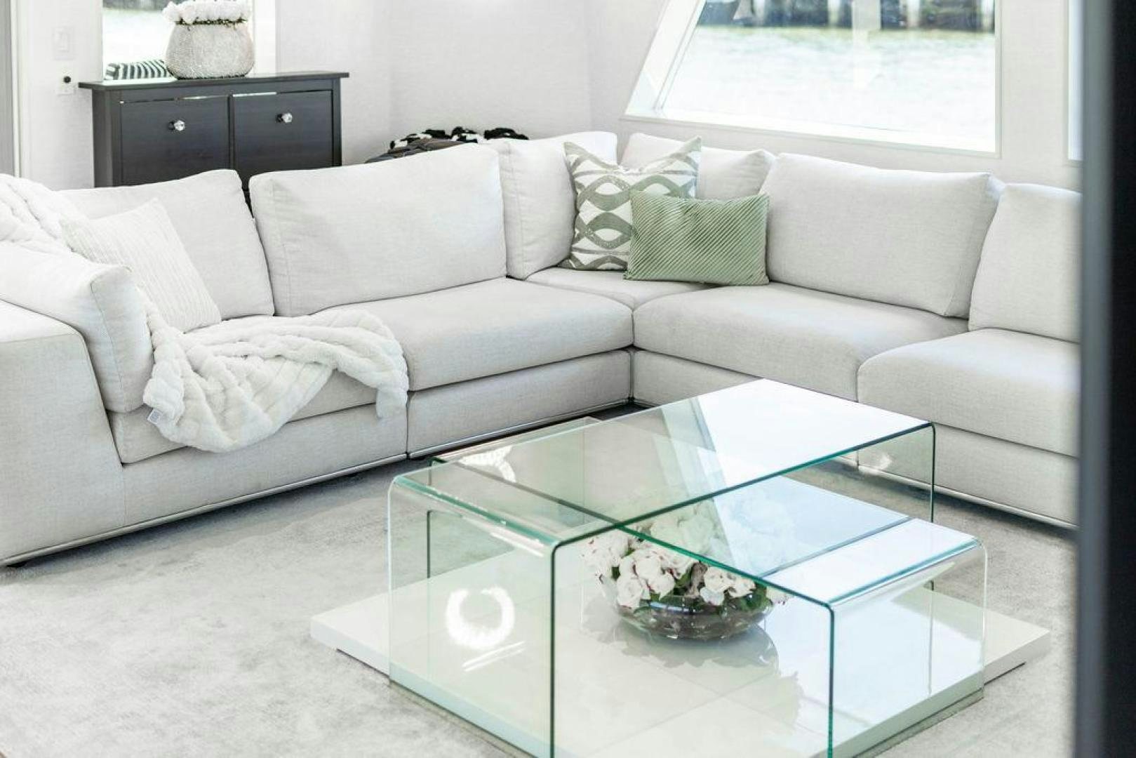 a white couch with a coffee table aboard THREE BLESSINGS Yacht for Sale