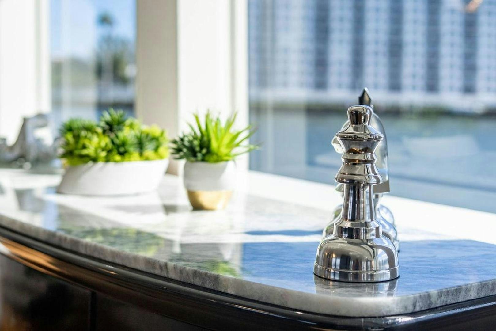 a glass vase with flowers on a window sill aboard THREE BLESSINGS Yacht for Sale