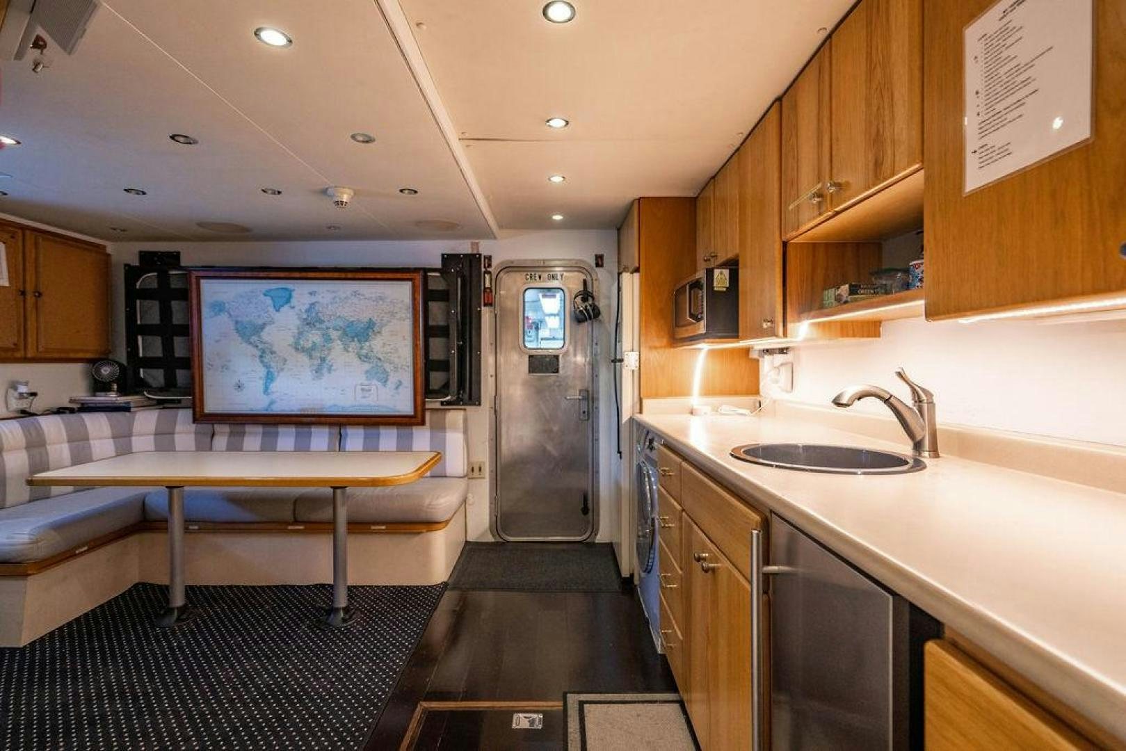 a kitchen with a table and a refrigerator aboard THREE BLESSINGS Yacht for Sale