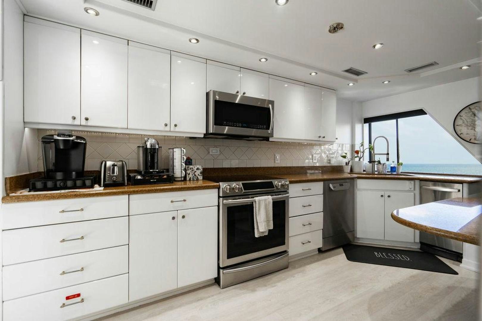 a kitchen with white cabinets aboard THREE BLESSINGS Yacht for Sale