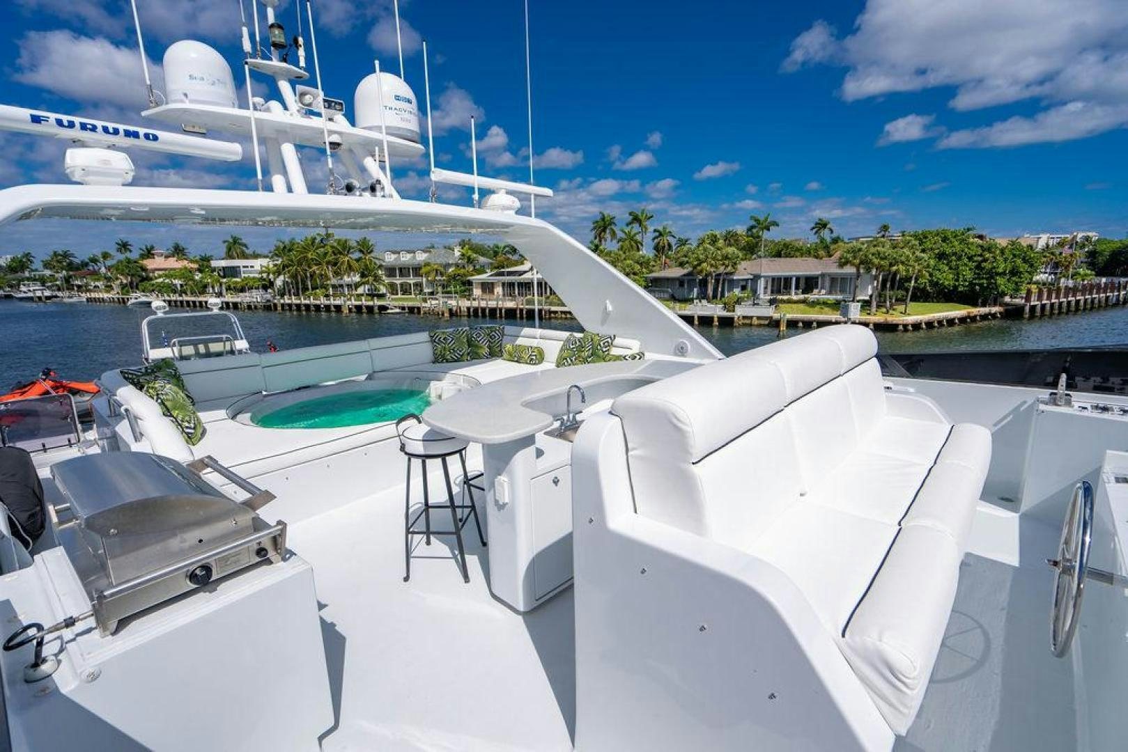 a deck with a deck and chairs and a large cruise ship in the background aboard THREE BLESSINGS Yacht for Sale