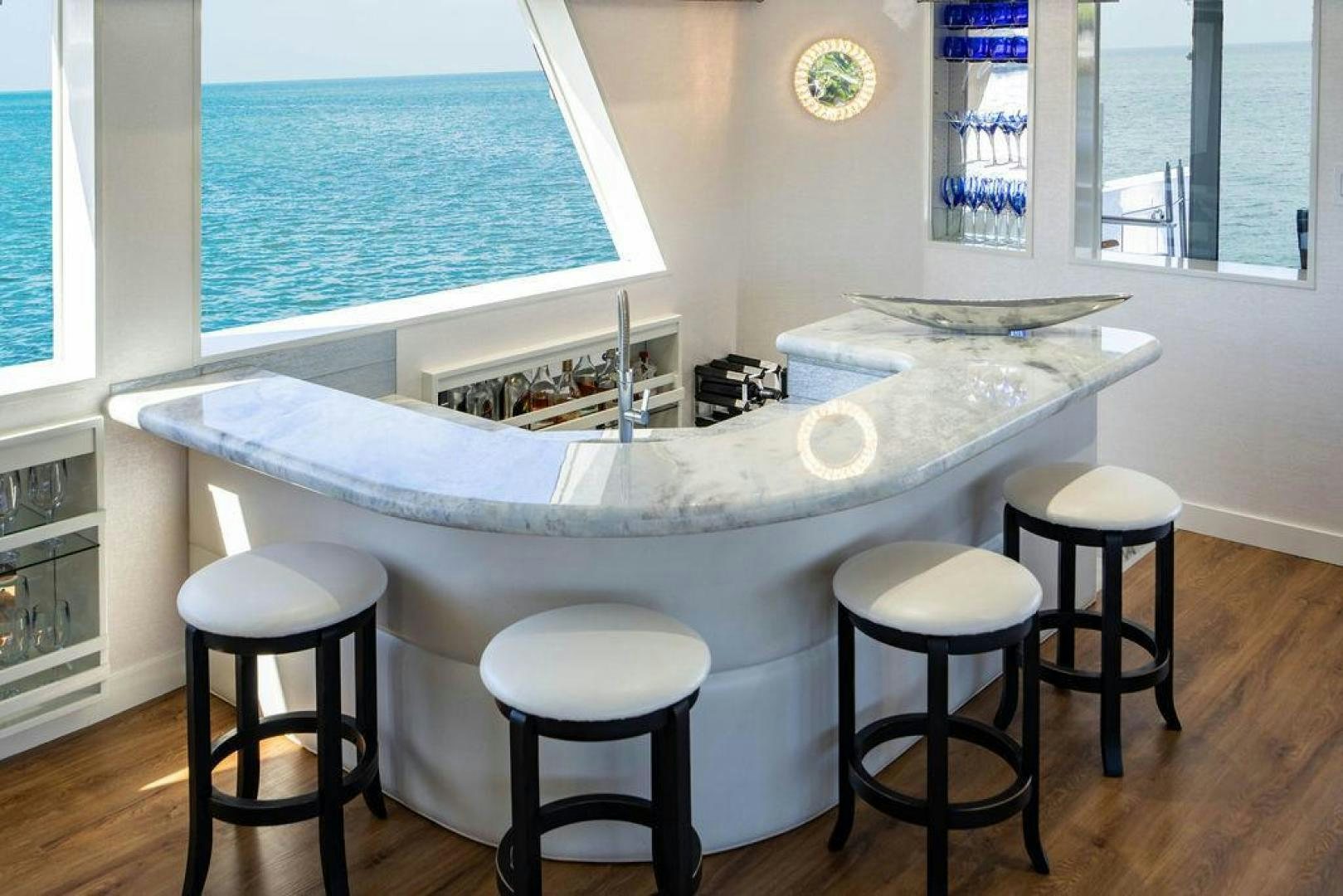 a large white table with stools and stools aboard THREE BLESSINGS Yacht for Sale