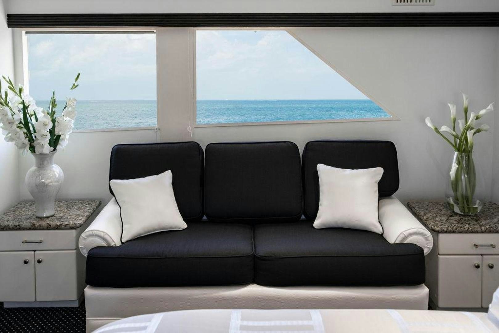 a black couch with white pillows aboard THREE BLESSINGS Yacht for Sale