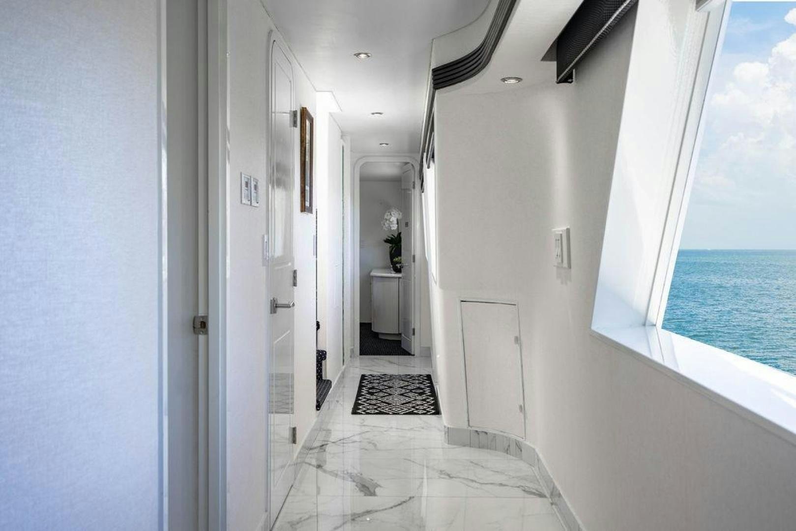 a hallway with a door and a pool aboard THREE BLESSINGS Yacht for Sale