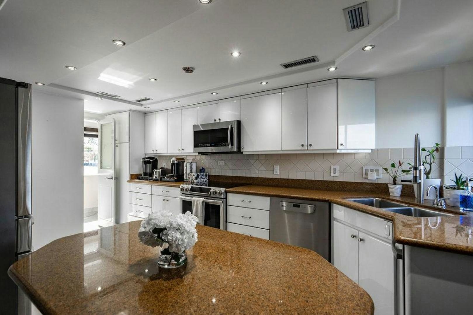 a kitchen with white cabinets aboard THREE BLESSINGS Yacht for Sale