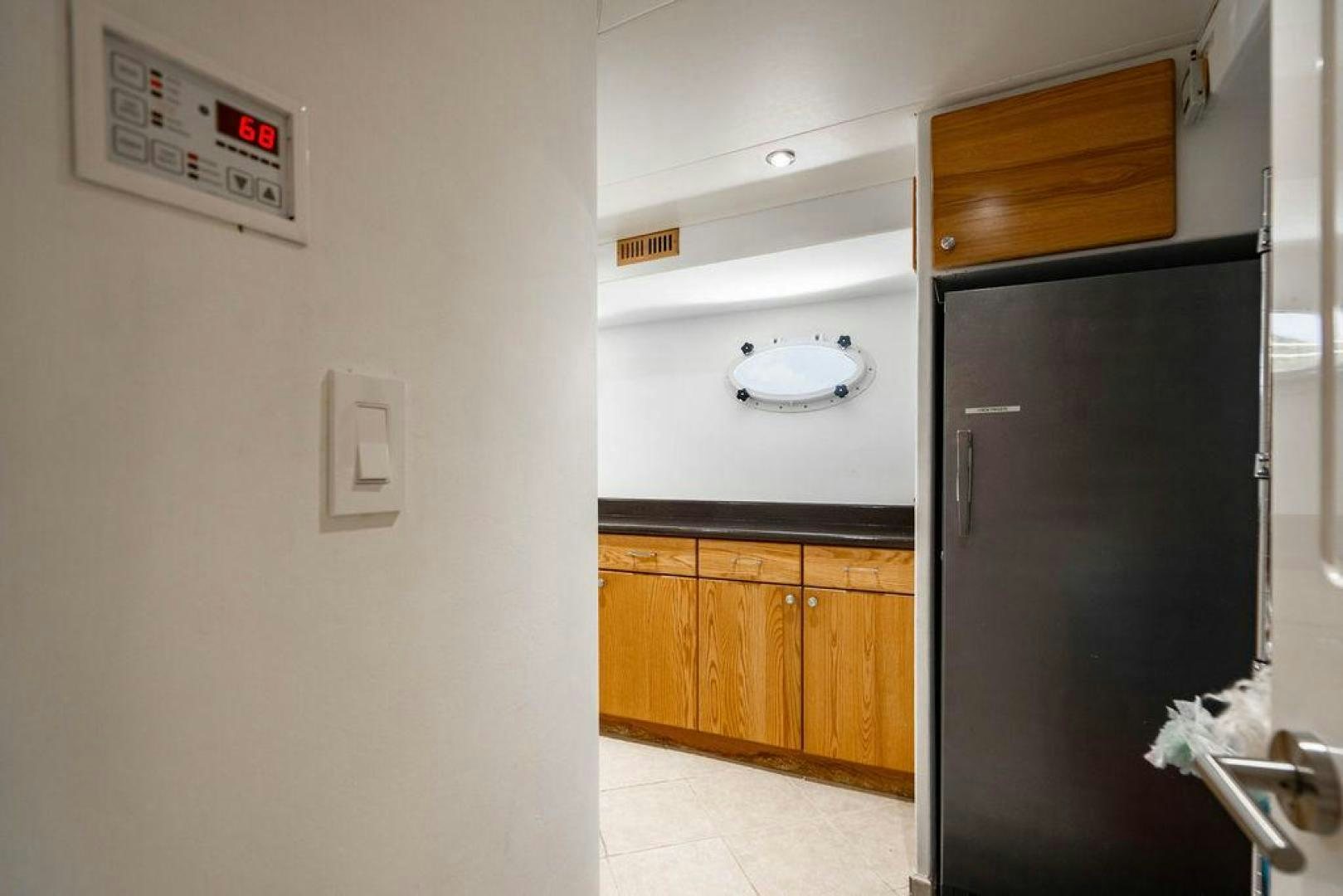 a room with a black refrigerator aboard THREE BLESSINGS Yacht for Sale