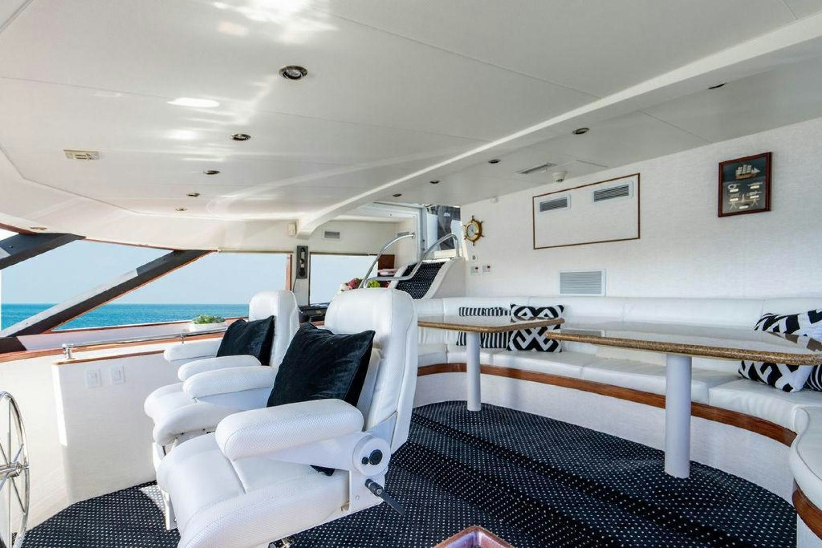 a room with a bed and a chair aboard THREE BLESSINGS Yacht for Sale