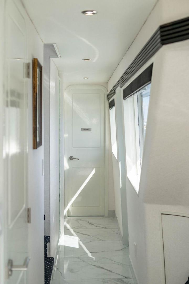 a hallway with white doors aboard THREE BLESSINGS Yacht for Sale