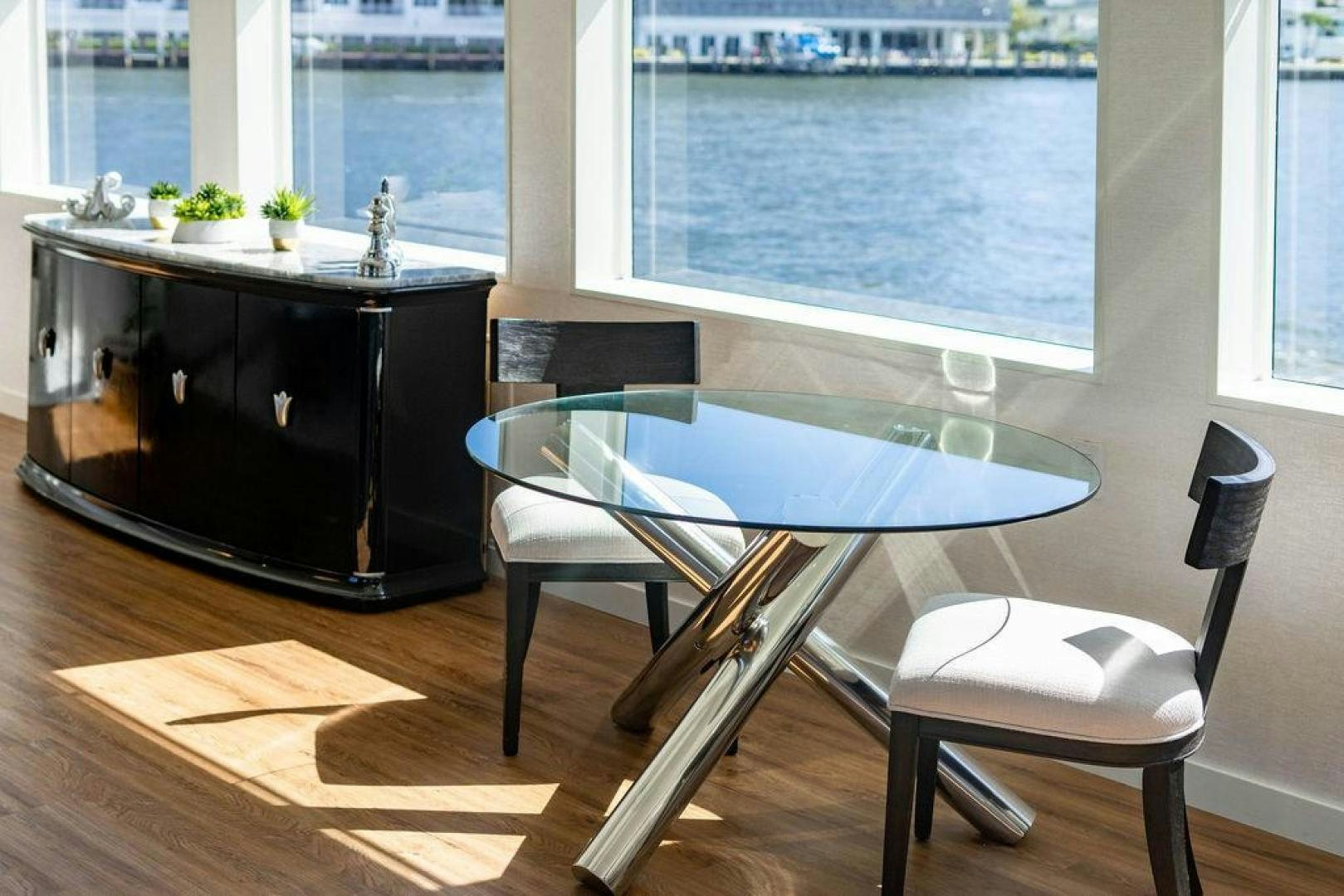 a table and chairs in front of a window aboard THREE BLESSINGS Yacht for Sale