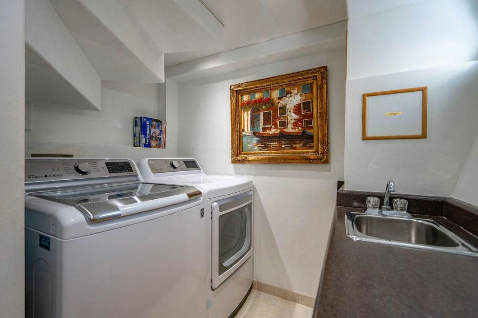 a kitchen with a painting on the wall aboard THREE BLESSINGS Yacht for Sale
