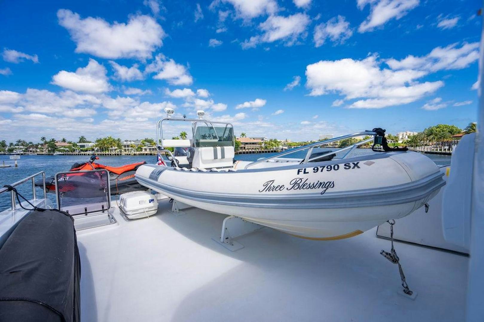 a boat with a red and white stripe on the front aboard THREE BLESSINGS Yacht for Sale