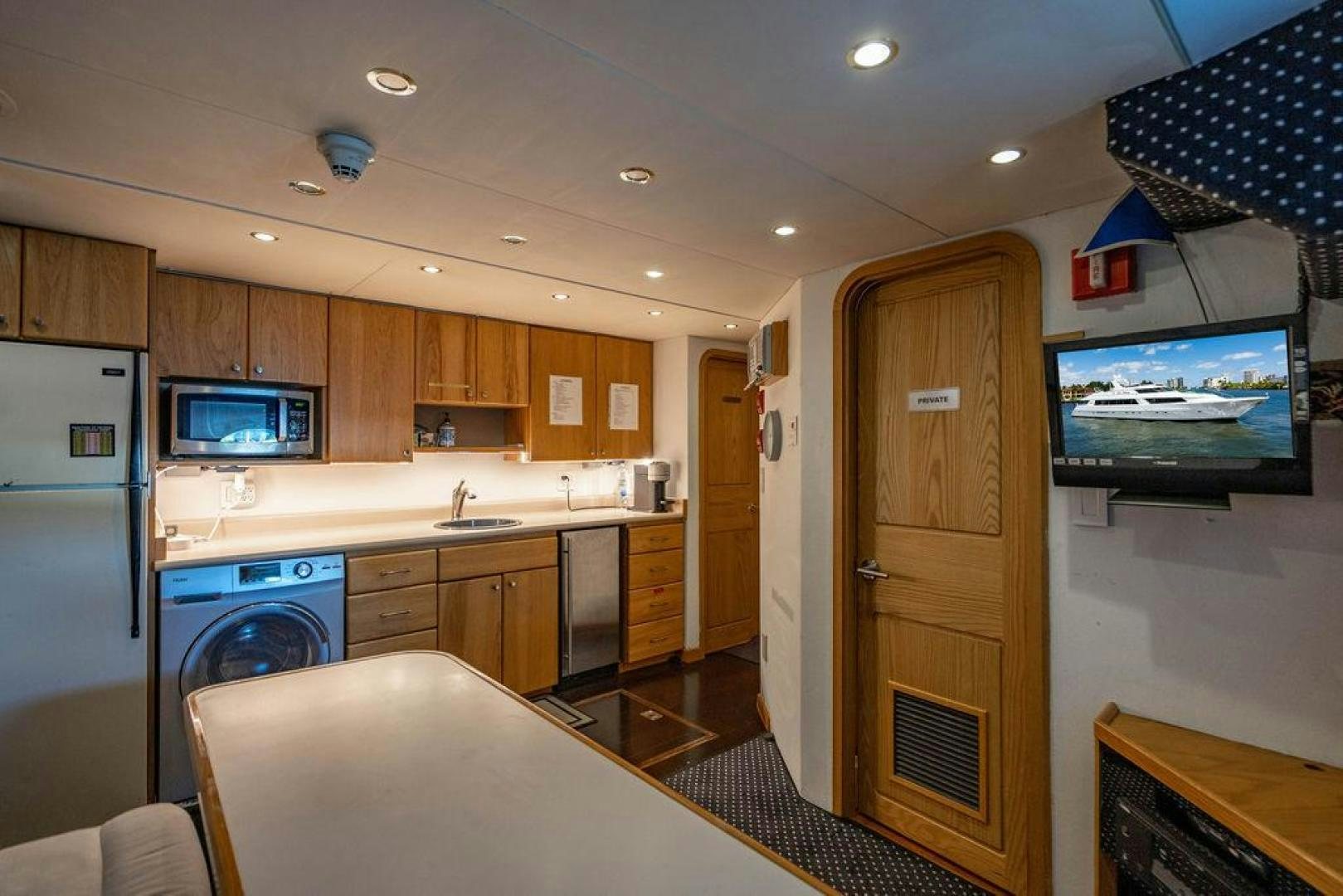 a kitchen with a table and tv aboard THREE BLESSINGS Yacht for Sale