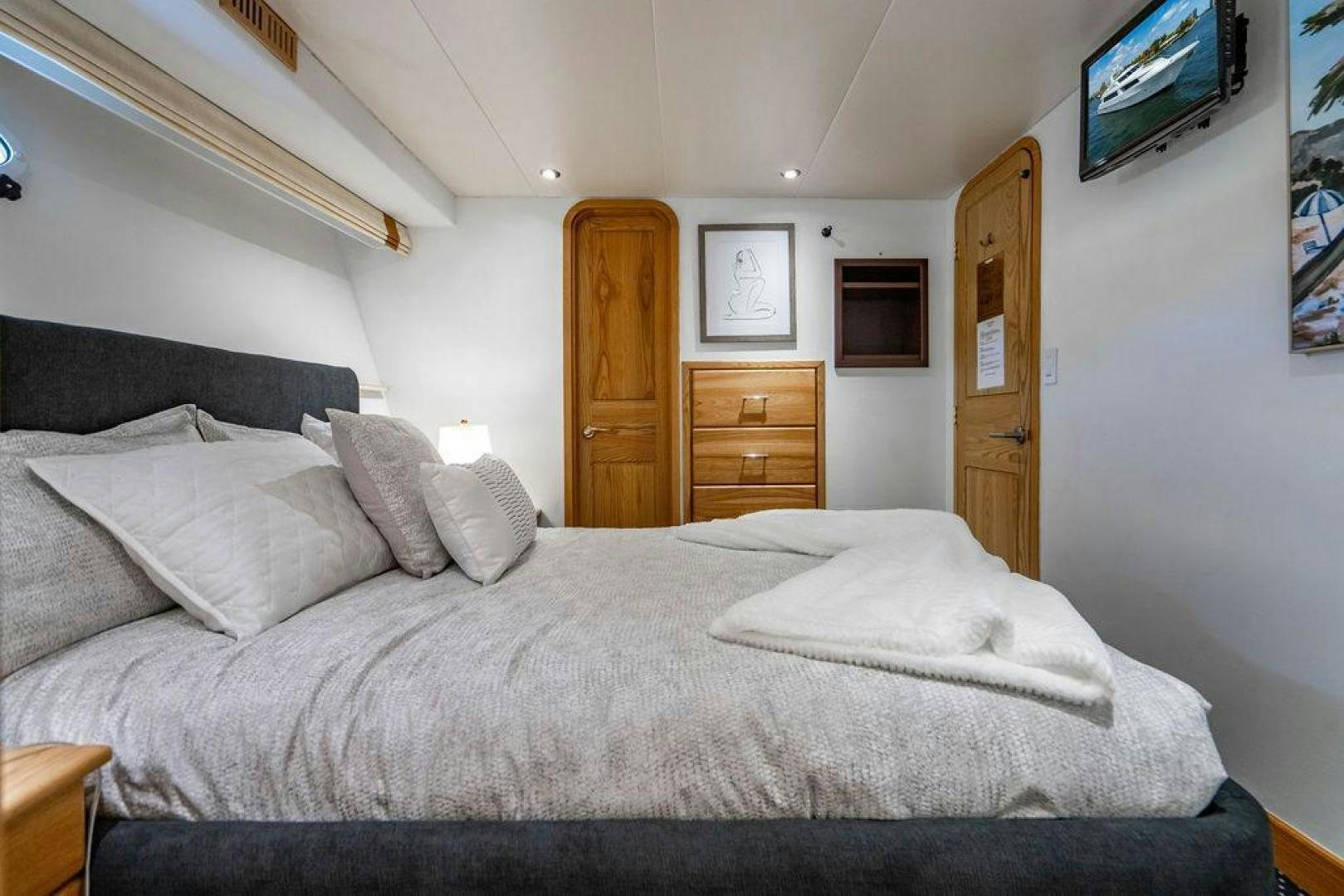 a bed with white sheets aboard THREE BLESSINGS Yacht for Sale