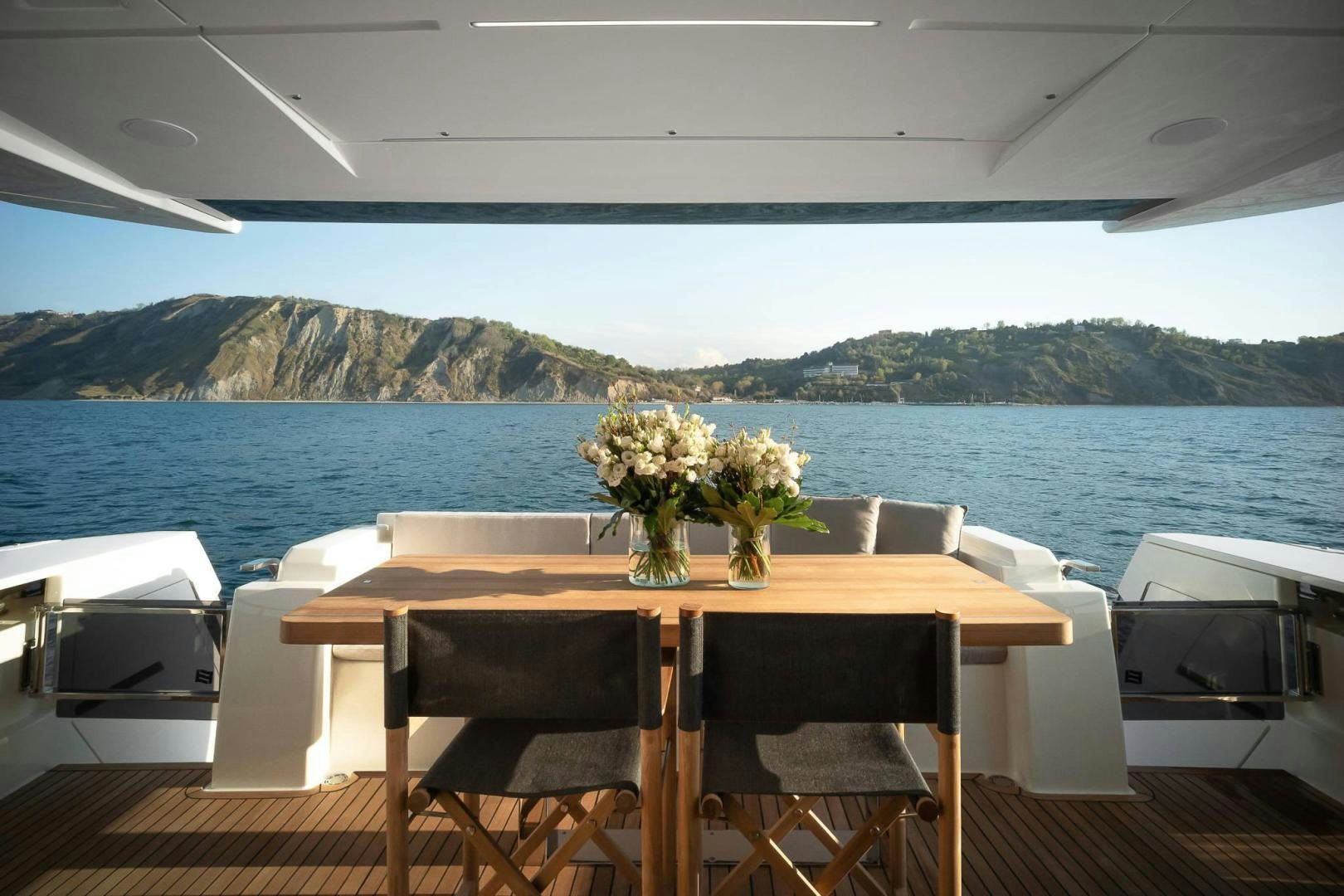 a table with flowers on it aboard ALVEARE Yacht for Sale