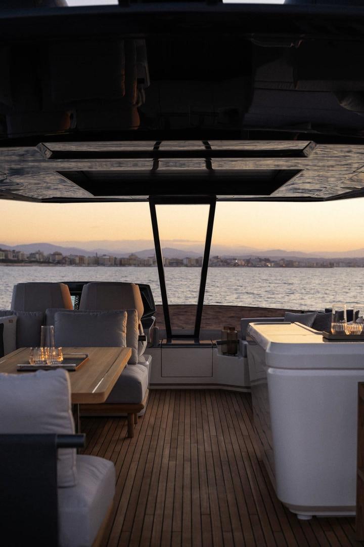 a deck with a table and chairs aboard ALVEARE Yacht for Sale