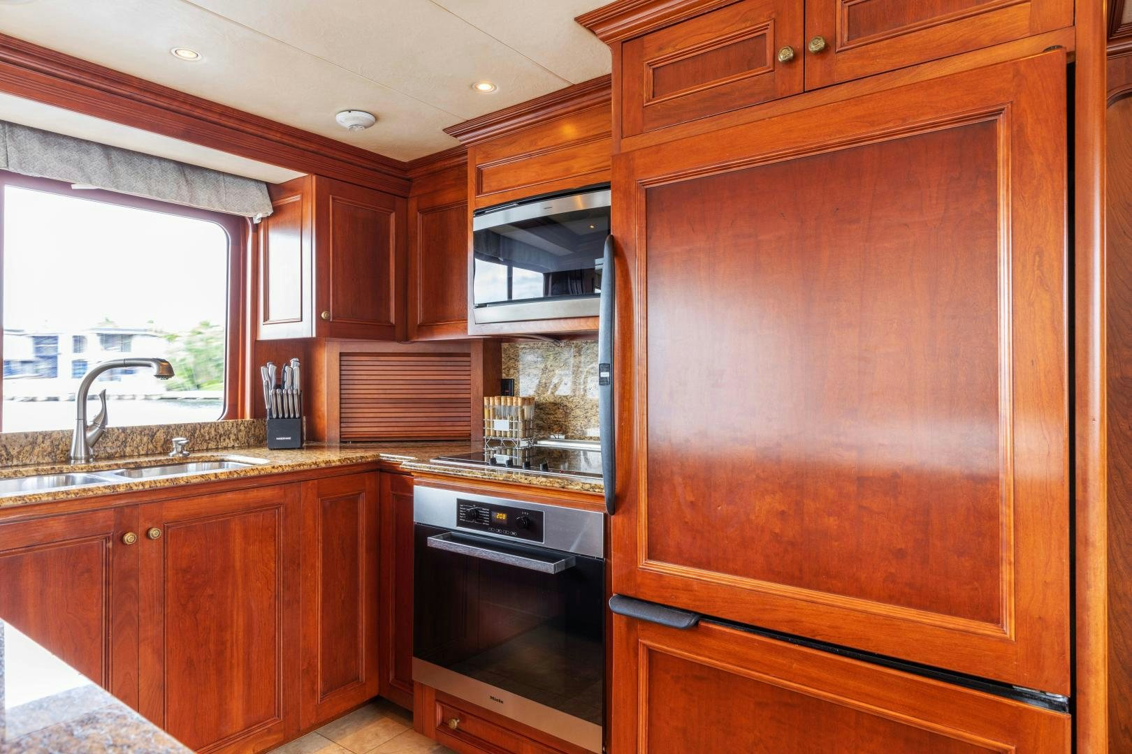 a kitchen with wooden cabinets aboard SIMARON Yacht for Sale