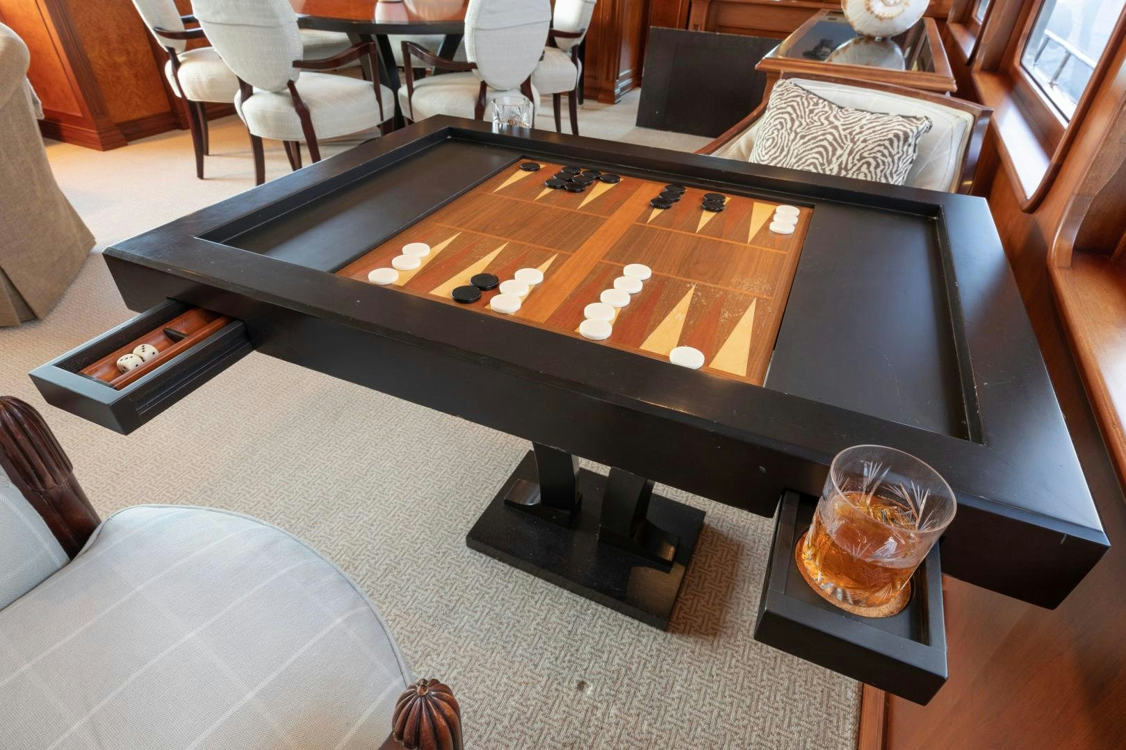 a coffee table with a glass of water on it aboard SIMARON Yacht for Sale