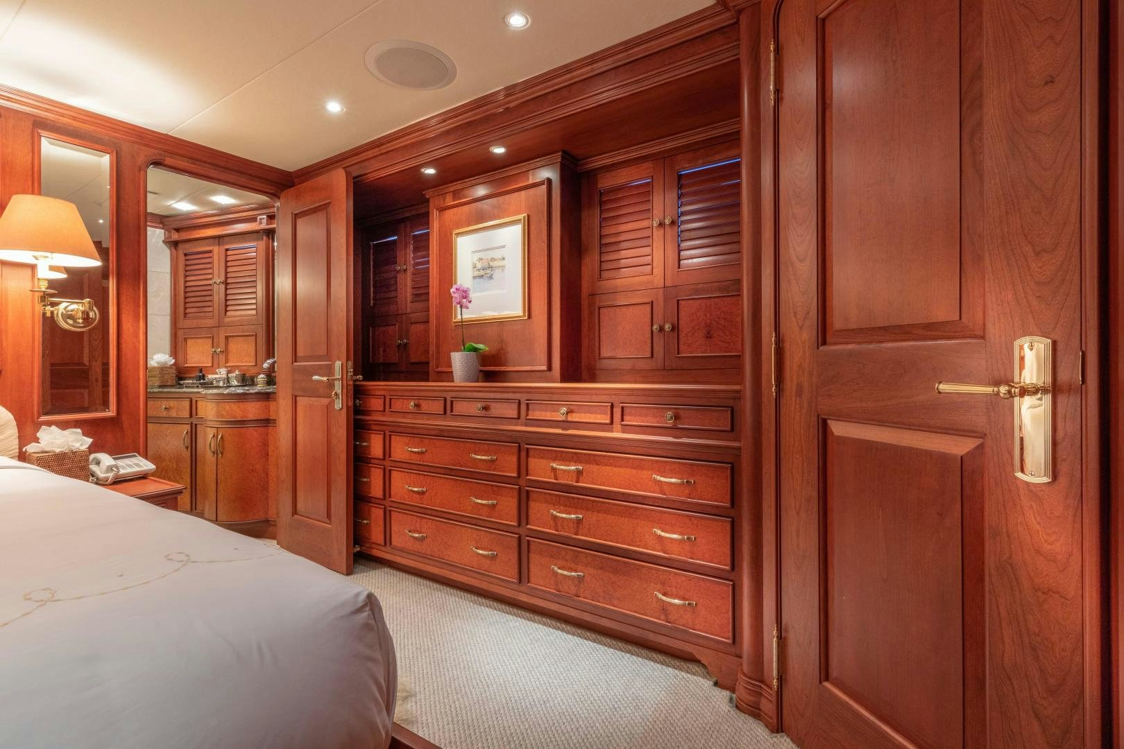 a bedroom with a bed and cabinets aboard SIMARON Yacht for Sale